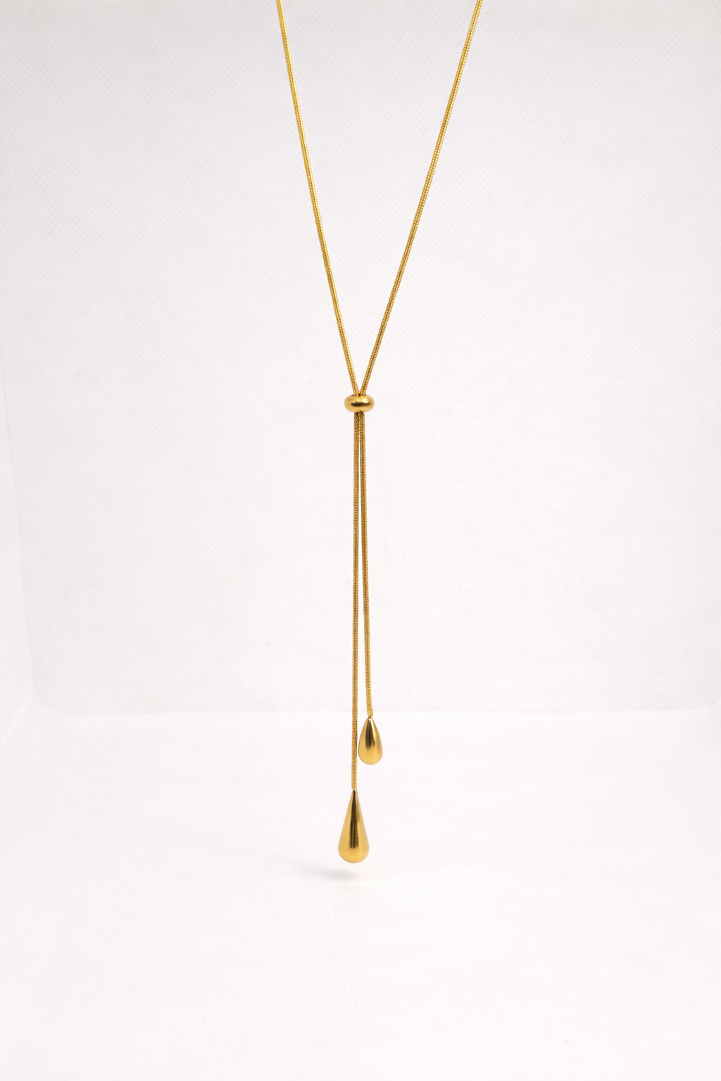 Gold drop necklace with teardrop pendants — elegant, minimal and fluid design.