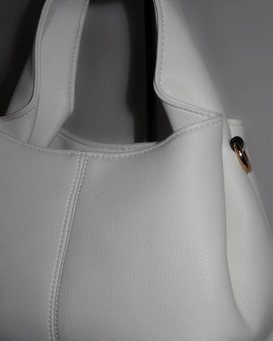 White sculptural handbag by Atelier Épure elegant, timeless, and effortlessly refined.