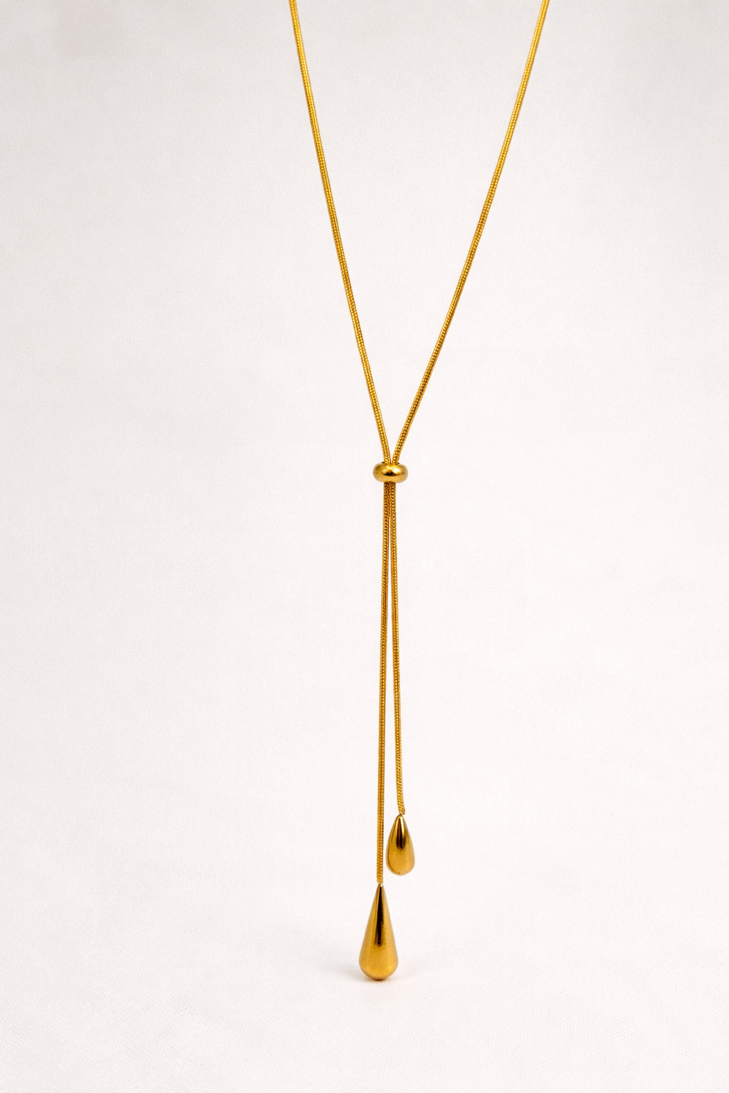 Gold drop necklace with teardrop pendants — elegant, minimal and fluid design.