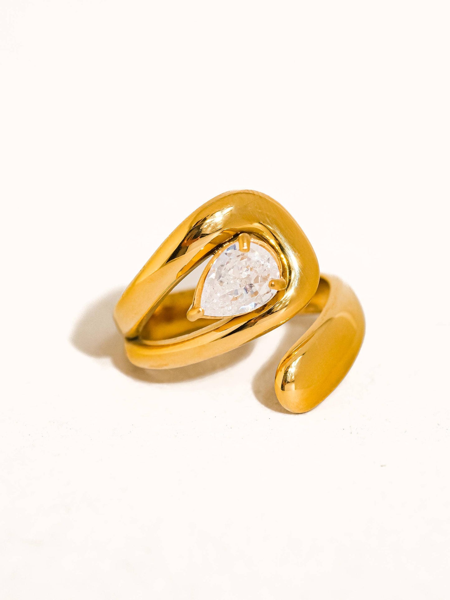 Evoke, an 18K gold-plated stainless steel wrap ring with a CZ crystal by Atelier ÉPURE. Elegant, sculptural, and crafted for everyday sophistication.