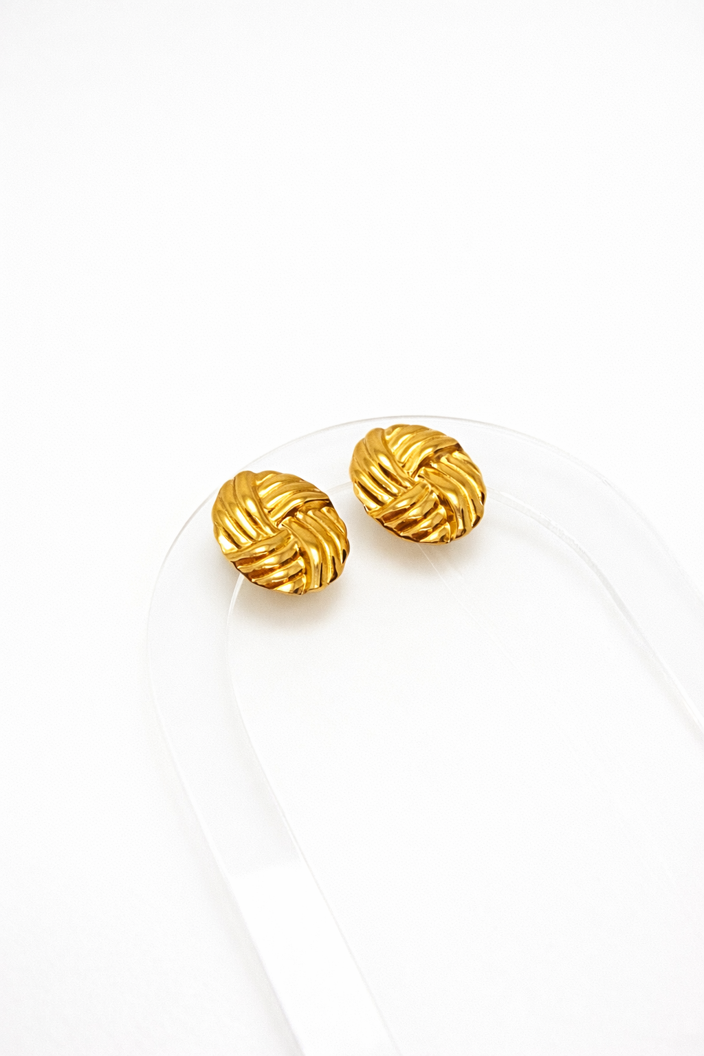 Gold sculpted earrings by Atelier Épure with a textured knot-inspired design — elegant, timeless, and refined.