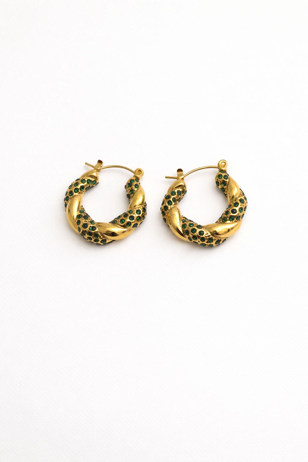 Gold twisted hoop earrings with green zirconia stones by Atelier Épure — bold, elegant, and refined.