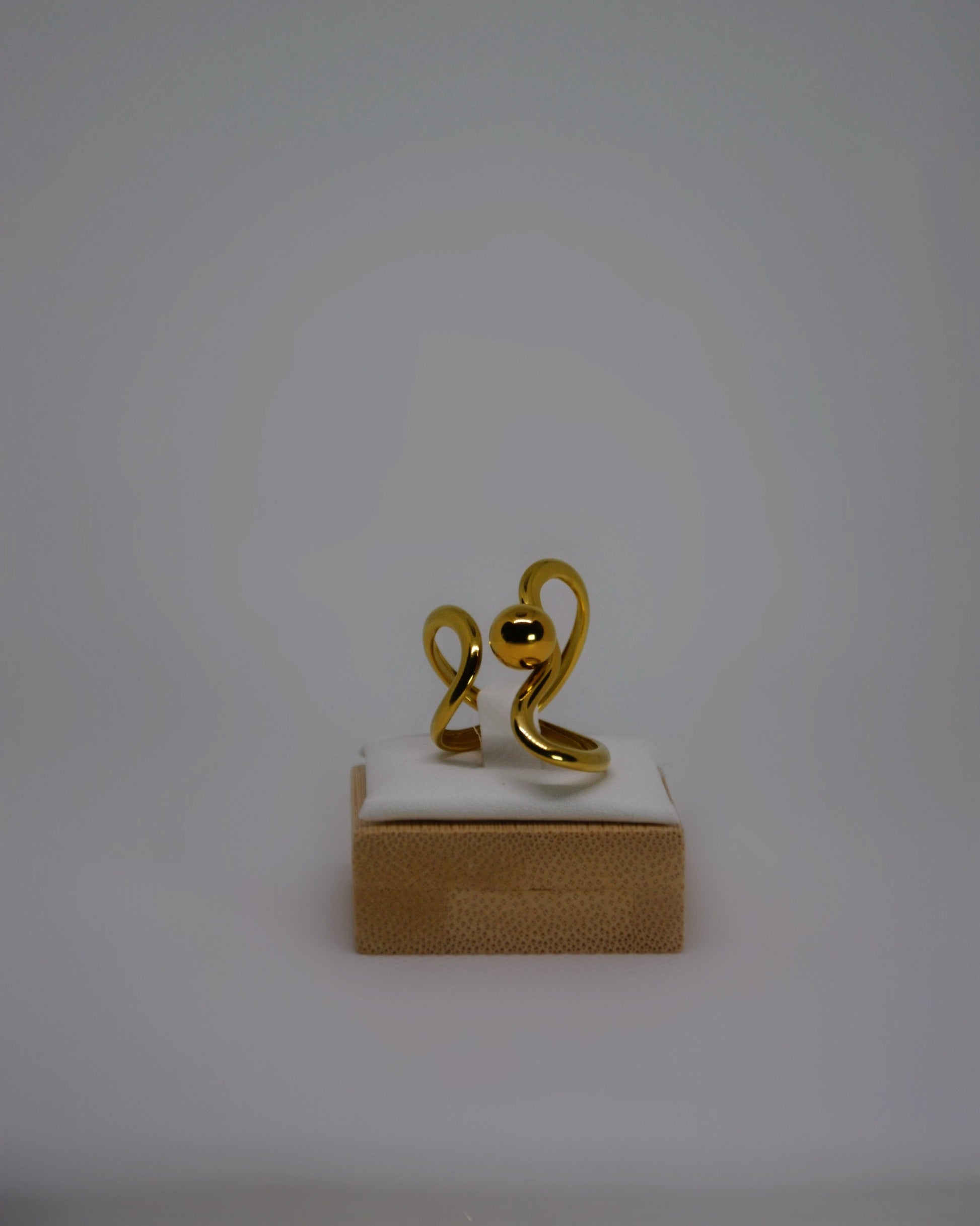 Lune Dorée Ring, gold-plated stainless steel ring by Atelier ÉPURE, featuring a sculptural curved design and polished golden shine.