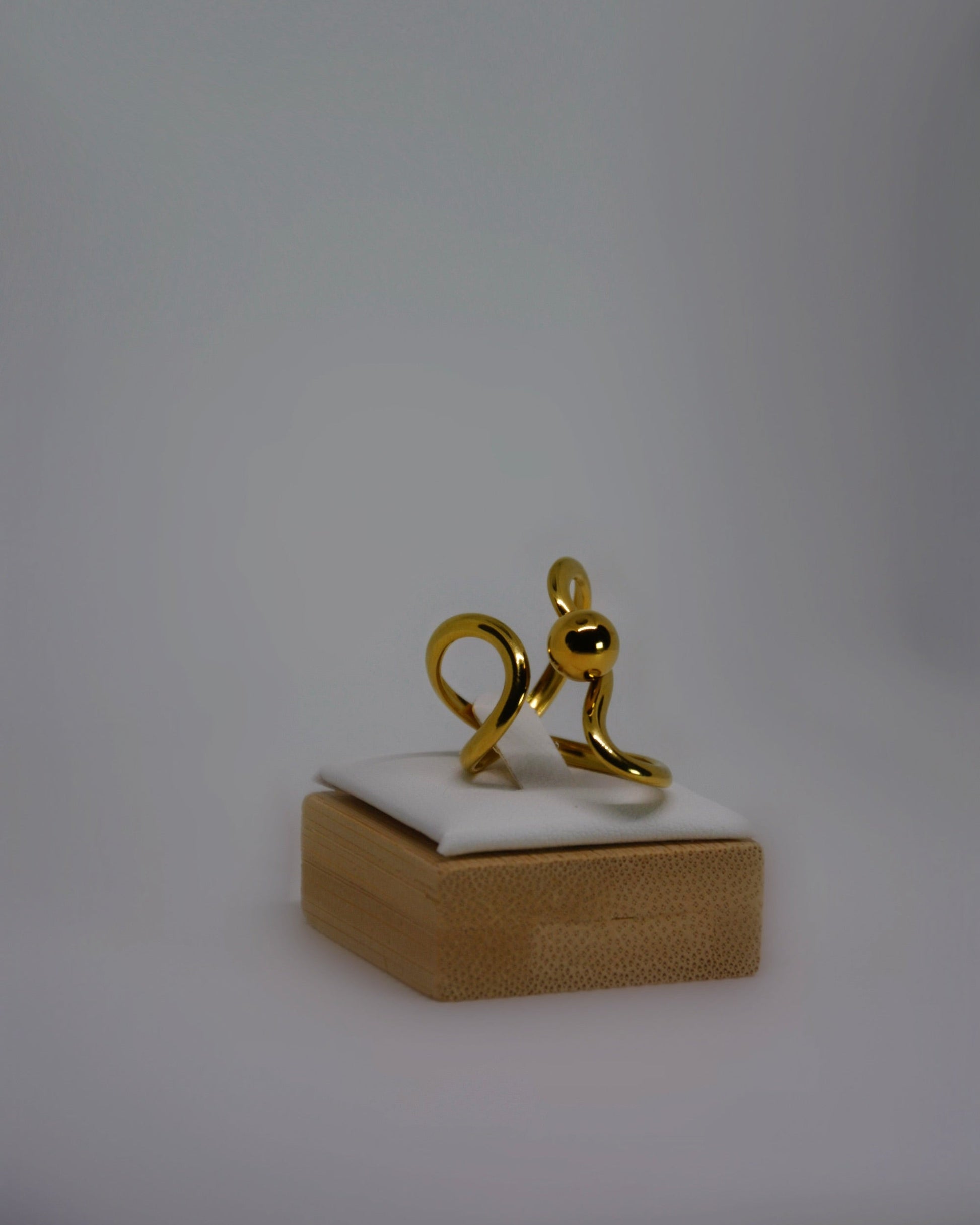 Lune Dorée Ring, gold-plated stainless steel ring by Atelier ÉPURE, featuring a sculptural curved design and polished golden shine.