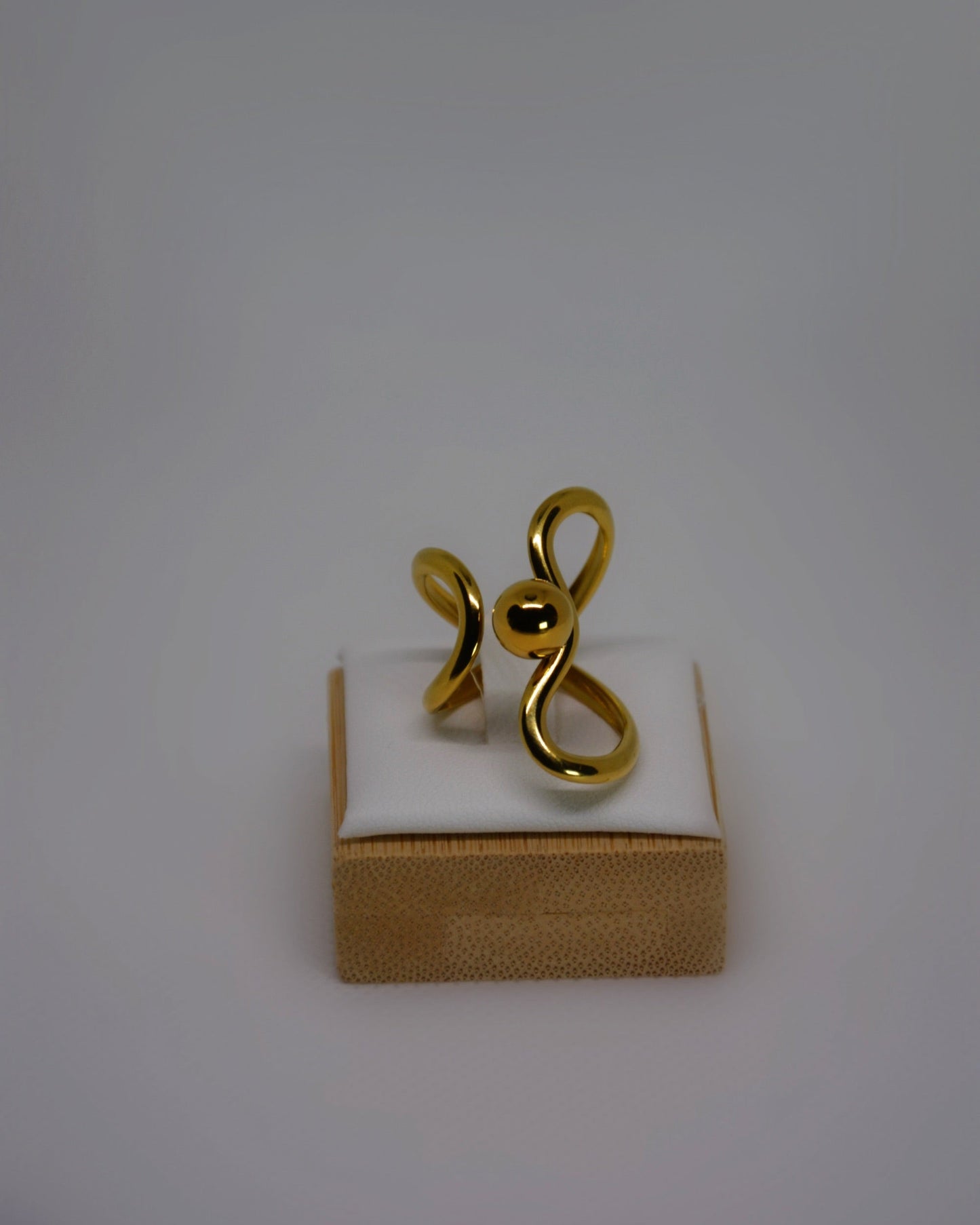 Lune Dorée Ring, gold-plated stainless steel ring by Atelier ÉPURE, featuring a sculptural curved design and polished golden shine.