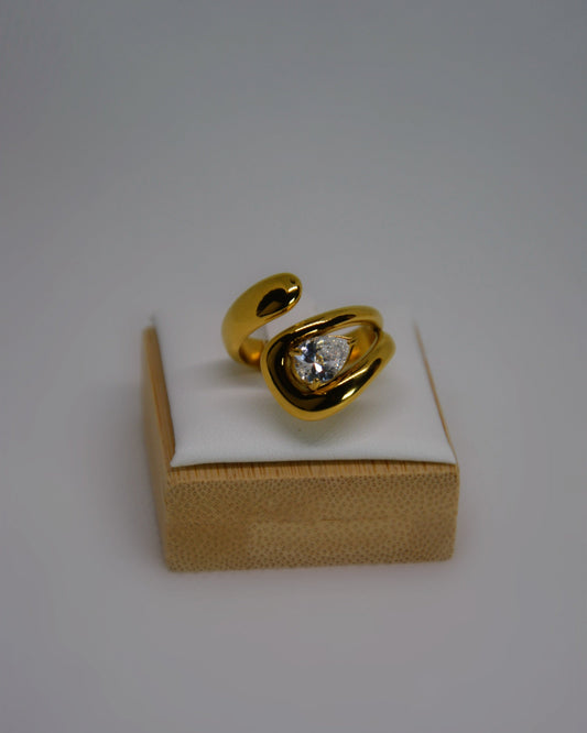 Evoke, an 18K gold-plated stainless steel wrap ring with a CZ crystal by Atelier ÉPURE. Elegant, sculptural, and crafted for everyday sophistication.