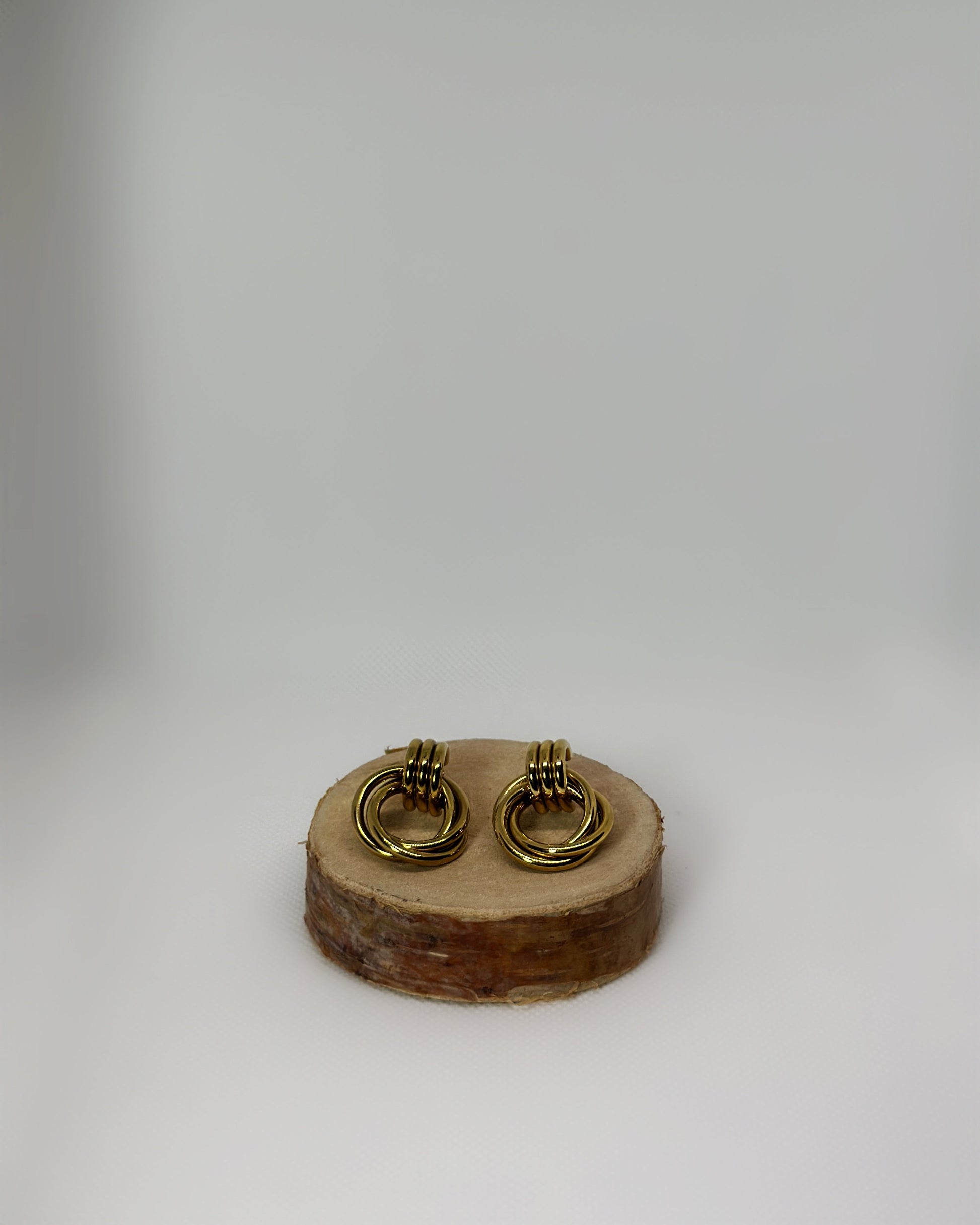 Lyra stainless-steel knot earrings by Atelier Épure. Elegant, timeless, and sculptural. Effortless sophistication designed to last.