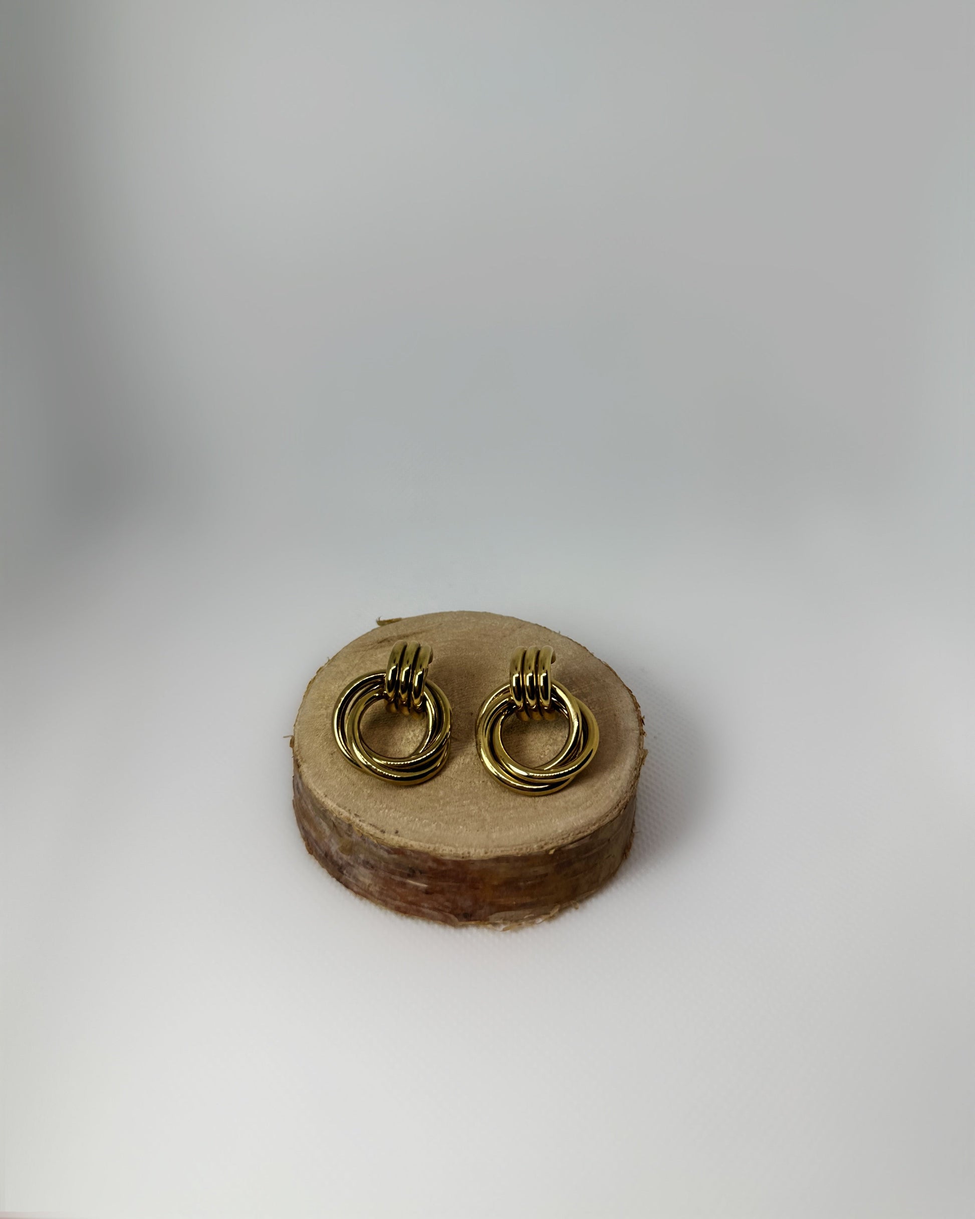 Lyra stainless-steel knot earrings by Atelier Épure. Elegant, timeless, and sculptural. Effortless sophistication designed to last.