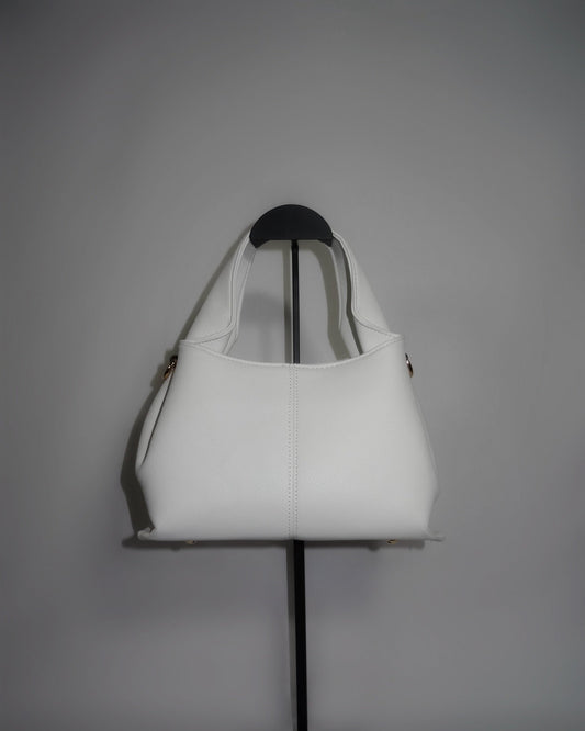White sculptural handbag by Atelier Épure elegant, timeless, and effortlessly refined.